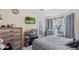 Cozy bedroom with a ceiling fan, TV, and closet space near a window with curtains at 31 Fairview Oak Cv, Dallas, GA 30157