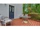 Back deck featuring outdoor seating with a metal table and umbrella at 31 Fairview Oak Cv, Dallas, GA 30157