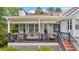 Inviting front porch with seating, flowers, and charming details at 31 Fairview Oak Cv, Dallas, GA 30157