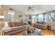 Bright living room with hardwood floors, neutral paint, a ceiling fan, and comfortable seating at 31 Fairview Oak Cv, Dallas, GA 30157