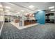 Spacious community area includes a central island with bar seating, wood accents, and modern lighting fixtures at 620 Peachtree Ne St # 601, Atlanta, GA 30308
