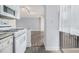 View of the well-lit kitchen showcases the updated appliances and adjacent living area, extending to a private balcony at 620 Peachtree Ne St # 601, Atlanta, GA 30308