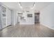 Inviting living space with light wood-look flooring, a pass-through kitchen bar, and access to a private balcony at 620 Peachtree Ne St # 601, Atlanta, GA 30308