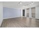 Bright living room features wood floors, light blue accent wall and access to a private balcony with sliding glass doors at 620 Peachtree Ne St # 601, Atlanta, GA 30308