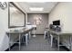 Compact work room featuring two workstations with stainless steel desks and carpeted floors at 620 Peachtree Ne St # 601, Atlanta, GA 30308