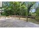 Wide backyard deck with black metal railing overlooks the large and private backyard at 6835 Sunny Brook Ln, Atlanta, GA 30328