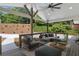 Stylish covered back porch featuring comfortable outdoor seating and views of the landscaped backyard at 6835 Sunny Brook Ln, Atlanta, GA 30328