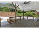 Spacious covered back porch with wood floors, ceiling fan, and railings overlooking the backyard at 6835 Sunny Brook Ln, Atlanta, GA 30328
