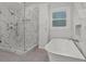 Modern bathroom featuring a glass enclosed shower, soaking tub, stylish tile and fixtures at 6835 Sunny Brook Ln, Atlanta, GA 30328