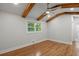Primary bedroom with hardwood floors, wooden ceiling beams, and bright natural light at 6835 Sunny Brook Ln, Atlanta, GA 30328