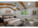 Bedroom with exposed wood beams, natural light, and neutral decor at 6835 Sunny Brook Ln, Atlanta, GA 30328