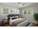 Inviting bedroom with large windows, a comfortable bed, and a modern ceiling fan at 6835 Sunny Brook Ln, Atlanta, GA 30328