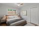 Cozy bedroom with neutral tones, a ceiling fan, and a double closet, creating a relaxing space at 6835 Sunny Brook Ln, Atlanta, GA 30328