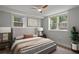 Stylishly furnished bedroom with a cozy bed, modern art, and leafy plant for enhanced comfort at 6835 Sunny Brook Ln, Atlanta, GA 30328