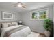 Bright bedroom featuring hardwood floors, natural light, a ceiling fan, and modern accents at 6835 Sunny Brook Ln, Atlanta, GA 30328