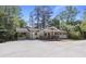 Inviting renovated home featuring a covered carport, and a lovely front porch, surrounded by mature trees at 6835 Sunny Brook Ln, Atlanta, GA 30328