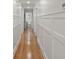 Hallway with white trim, hardwood floors, and access to a bathroom at 6835 Sunny Brook Ln, Atlanta, GA 30328