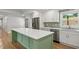 Beautiful kitchen with stone backsplash, stainless appliances, and sage green island at 6835 Sunny Brook Ln, Atlanta, GA 30328