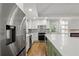 Modern kitchen with stainless steel appliances and a large island with white countertop at 6835 Sunny Brook Ln, Atlanta, GA 30328