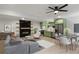Open concept living space with modern fireplace, green kitchen cabinets, and dining area, perfect for entertaining at 6835 Sunny Brook Ln, Atlanta, GA 30328