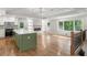 Open-concept living room and kitchen with hardwood floors, fireplace, and ample natural light at 6835 Sunny Brook Ln, Atlanta, GA 30328