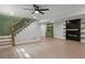 Spacious living area with stairs, fireplace feature wall, and green accent cabinets, offering modern comfort at 6835 Sunny Brook Ln, Atlanta, GA 30328