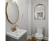 Stylish powder room with gold framed mirrors and faucet, offering a touch of elegance at 6835 Sunny Brook Ln, Atlanta, GA 30328