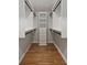 Bright walk-in closet with custom shelving, drawers, and wooden floors, offering ample storage space at 6835 Sunny Brook Ln, Atlanta, GA 30328