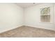 This bedroom features neutral walls, carpet, and a window with blinds at 11130 Benton Woods Dr, Covington, GA 30014