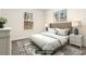 This bedroom features a decorative rug, tufted headboard, and ample natural light at 11130 Benton Woods Dr, Covington, GA 30014