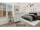 This bedroom offers natural light, a ceiling fan, and modern decor at 11130 Benton Woods Dr, Covington, GA 30014