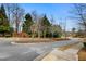 Street view of community entrance with well-maintained landscaping and signage at 11130 Benton Woods Dr, Covington, GA 30014