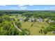 Scenic aerial view showcasing expansive properties with verdant landscapes and mature trees at 3920 Ineal Dr, Cumming, GA 30028