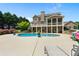 Spacious backyard featuring a kidney-shaped pool, patio furniture and a two-story home at 3920 Ineal Dr, Cumming, GA 30028