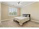 Bedroom with carpeted floor, neutral paint, ceiling fan, and a window with shutters at 3920 Ineal Dr, Cumming, GA 30028