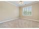 Unfurnished bedroom with plush carpeting, white trim, and a bright window with shutters at 3920 Ineal Dr, Cumming, GA 30028