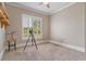 Cozy bedroom features carpeted floors, shuttered windows for natural light, and a serene atmosphere at 3920 Ineal Dr, Cumming, GA 30028