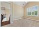 Empty bedroom with neutral paint, carpeted floors, and bright window with shutters at 3920 Ineal Dr, Cumming, GA 30028