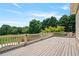Large outdoor deck with wooden railing overlooks a lush green landscape at 3920 Ineal Dr, Cumming, GA 30028