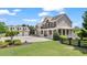 Spacious home with a wrap-around porch, well-manicured lawn, and porte-cochère, perfect for outdoor living at 3920 Ineal Dr, Cumming, GA 30028