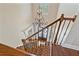 Entryway featuring a staircase with iron railings, hardwood floors, and a view of the elegant chandelier at 3920 Ineal Dr, Cumming, GA 30028