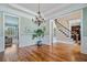 Spacious foyer with hardwood floors and detailed trim opens to living spaces and a staircase at 3920 Ineal Dr, Cumming, GA 30028