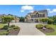 Stately home with a porte-cochère, lush landscaping, brick, stone, and a circular driveway at 3920 Ineal Dr, Cumming, GA 30028