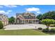 Beautiful home featuring brick and stone accents, a wrap-around porch, and a circular driveway at 3920 Ineal Dr, Cumming, GA 30028