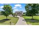 A beautiful two-story home with a long driveway lined with trees and a well-manicured lawn at 3920 Ineal Dr, Cumming, GA 30028