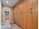 Hallway with built in wooden storage cabinets and tiled floors at 3920 Ineal Dr, Cumming, GA 30028
