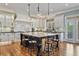 Spacious kitchen featuring a large island with bar seating, custom cabinets, and pendant lighting at 3920 Ineal Dr, Cumming, GA 30028