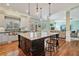 Stylish kitchen featuring a large island with seating, stainless steel appliances, and hardwood floors at 3920 Ineal Dr, Cumming, GA 30028