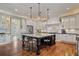 Gourmet kitchen with a large center island, white cabinetry, and stainless steel appliances at 3920 Ineal Dr, Cumming, GA 30028