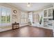 Bright living room boasts beautiful hardwood floors, built-in shelving, and natural light from shuttered windows at 3920 Ineal Dr, Cumming, GA 30028